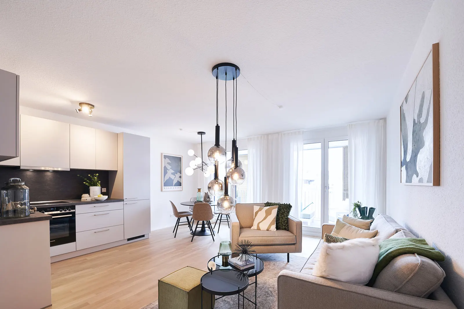 Wohn-Essbereich einer Wohnung mit Einbauküche und bodentiefen Fenstern